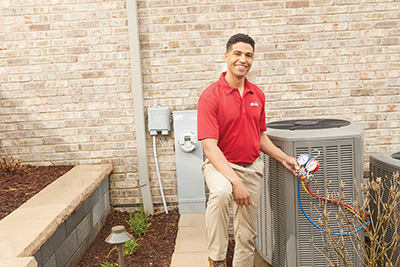 Air Conditioning technician checking an AC's refrigerant level