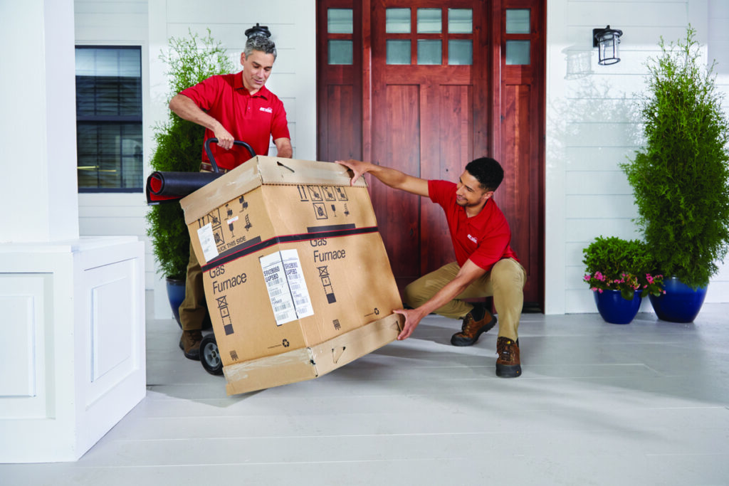 Technicians delivering a furnace for installation