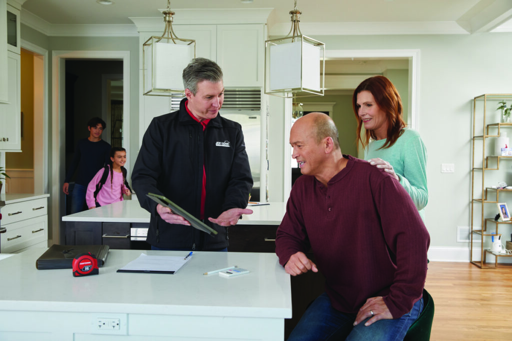 Service rep meeting with homeowners to discuss their service options